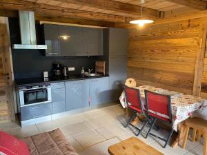 a kitchen with a table and chairs in a room at Appartement La Clusaz, 3 pièces, 6 personnes - FR-1-459-28 in La Clusaz