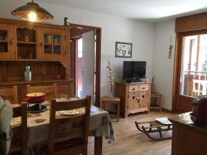 a living room with a table and a television at Appartement La Clusaz, 2 pièces, 6 personnes - FR-1-459-38 in La Clusaz