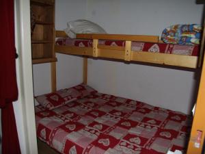 a bedroom with two bunk beds with a red blanket at Appartement La Clusaz, 2 pièces, 6 personnes - FR-1-459-38 in La Clusaz