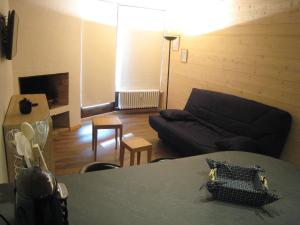 a living room with a couch and a table at Studio La Clusaz, 1 pièce, 4 personnes - FR-1-459-62 in La Clusaz