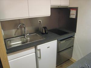 a small kitchen with a sink and a stove at Studio La Clusaz, 1 pièce, 4 personnes - FR-1-459-62 in La Clusaz