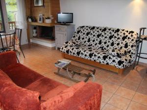 a living room with two couches and a tv at Appartement La Clusaz, 2 pièces, 4 personnes - FR-1-459-110 in La Clusaz