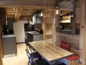 a kitchen with a table and chairs in a room at Appartement La Clusaz, 3 pièces, 6 personnes - FR-1-459-136 in La Clusaz