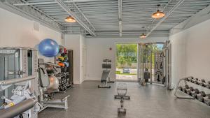 a fitness room with a gym with weights and equipment at All-New, Waterfront Condo in Downtown Sarasota! in Sarasota