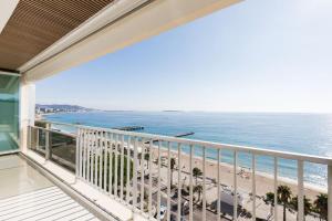 een balkon met uitzicht op het strand bij Vue mer exceptionnelle, appartement unique de luxe in Cannes