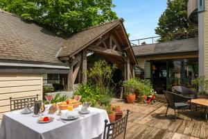 a table with a white table cloth on a deck at LeCoq-Gadby Hôtel & Spa, The Originals Relais in Rennes