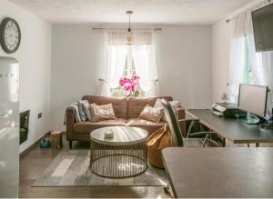 a living room with a couch and a table at Elegant 2 BR Apartment in Historic Cambridge in Papworth Everard