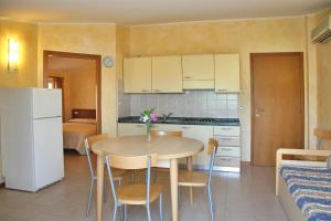 a kitchen with a table and chairs in a room at Residence Primavera in Bardolino
