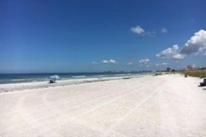 a sandy beach with the ocean in the background at Cozy Beach Rental 1B/1B in St. Pete Beach