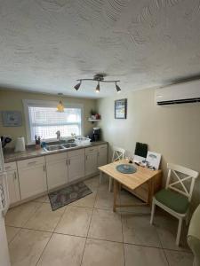 a kitchen with a table and a ceiling at Cozy Beach Rental 1B/1B in St Pete Beach