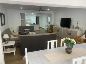 ein Wohnzimmer mit Sofa und Fernseher in der Unterkunft 150m2 Con vistas al Mar y al Castillo de Cullera in Cullera