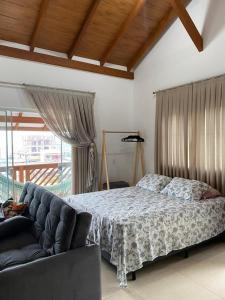 En eller flere senge i et værelse på Studio Recanto Beach Itapema