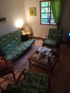 a living room with a couch and two chairs and a table at Pueblo del mar Tila' s house in Tamarindo