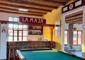 a pool table in a room with a bar at La Estancia Chincha Hotel in Chincha Alta