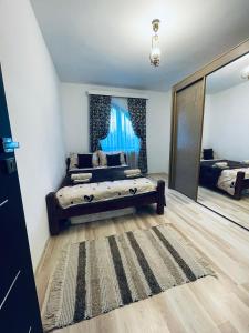 a bedroom with a bed and a large mirror at Casa POTE in Covasna