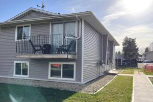 a house with two chairs on a balcony at Wonderful 2-bedroom apartment in Camrose