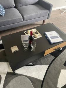 a black coffee table with a bottle of wine and glasses at Wonderful 2-bedroom apartment in Camrose