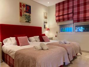 two beds sitting next to each other in a bedroom at ALCAZABA beach in Estepona