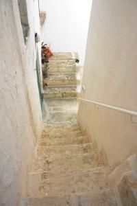 un callejón con escaleras en un viejo pueblo en RIFUGIO Salentro, en Botrugno