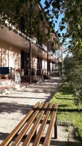 a wooden bench sitting in front of a building at Пансионат "Скиф-Мурок" in Bosteri