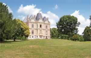 an old mansion on a grassy hill with trees at Awesome Home In Boure With 3 Bedrooms, Outdoor Swimming Pool And Heated Swimming Pool in Saint-Brice