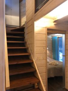 a staircase in a tiny house with a bed at Loma-asunto Kaarna, Kalajärvi in Peräseinäjoki