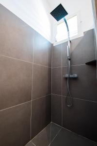 a bathroom with a shower with a window at EAST KEYS - Lucy's Bay in Hyacinthe