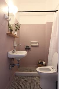 a bathroom with a sink and a toilet at Hippocampus studios 2 min walk from the beach in Moutsoúna