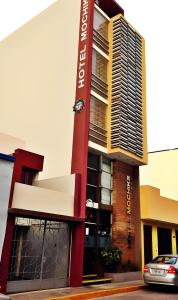 a building with a sign on the side of it at Hotel Mochiks in Chiclayo