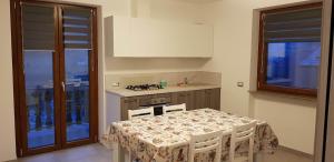 a kitchen with a table and a stove and a table and chairs at Casa Milia in Baceno