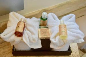 a tray with three bottles of soap and towels at Ocean front Villa in Cancun Hotel Zone in Cancún