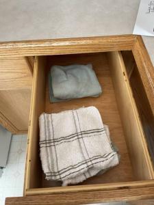 a wooden cabinet with two towels in it at Cozy Home in Camrose +34 photos