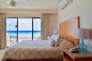 a bedroom with a bed with a view of the ocean at Ocean front Villa in Cancun Hotel Zone in Cancún