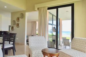 a living room with a table and chairs and a dining room at Ocean front Villa in Cancun Hotel Zone in Cancún