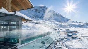 a view of a snow covered mountain from a building at Hotel das Seekarhaus in Obertauern