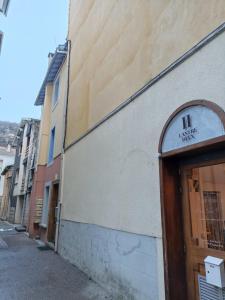 a building with a sign on the side of it at Studio Porteille d'Ax entièrement rénové ! in Ax-les-Thermes +5 photos