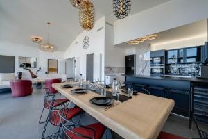 a large kitchen with a long table and chairs at LE SAPHIR in Annecy