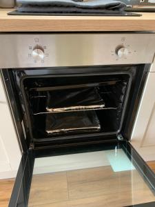 an oven with its door open in a kitchen at Loch an Eilean Pod Isle of South Uist in Pollachar