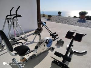 a group of three exercise bikes parked on a sidewalk at Natassa's View in Kerames