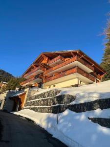 a building with snow in front of it at Apartment with stunning view! Ski-in, ski-out in Villars-sur-Ollon