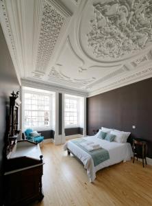 een slaapkamer met een bed en een schuin plafond bij Guimarães Studios Lounge in Guimarães