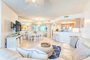 a living room with a couch and a kitchen at Southpoint #703 in Ponce Inlet