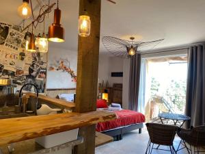 鲁西永Maison d'hôtes Une hirondelle en Provence的客房设有一张床和一张桌子及椅子