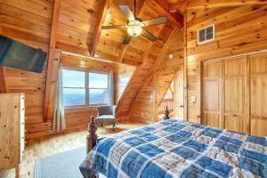 a bedroom with a bed and a ceiling fan at Hawk's View Log Cabin in Lake Lure