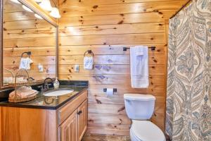 a wooden bathroom with a toilet and a sink at Hawk's View Log Cabin in Lake Lure +30 photos