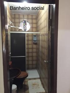 a bathroom with a shower with a toilet and a sink at Casa Amarela in Viçosa do Ceará