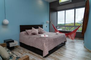 a bedroom with a bed with a hammock in it at Hotel El Meson in La Dorada