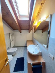 a bathroom with two sinks and two mirrors at Stefano Apartments Padova Spacious,with parking in Mestrino