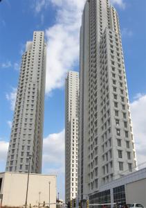 two tall white buildings in a city at Oak Sky Apartment Spa & Fitness in Skopje