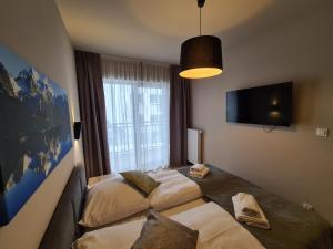 Posteľ alebo postele v izbe v ubytovaní Apartament D2 Karpatia - 5D Apartamenty